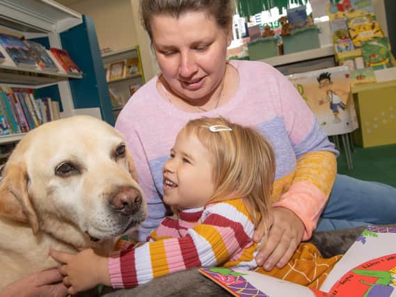 Ava Firthlock, pictured with her mother Kellie Hartnell and one of the therapy dogs, has benefitted from the reading sessions at Selby library