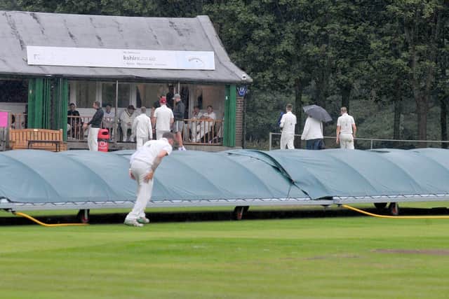 RAIN STOPPED PLAY: The covers come on after eight overs and that proved the end of play for the day between Aire Wharfe League rivals Horsforth Hall Park and Follifoot. Picture: Steve Riding.