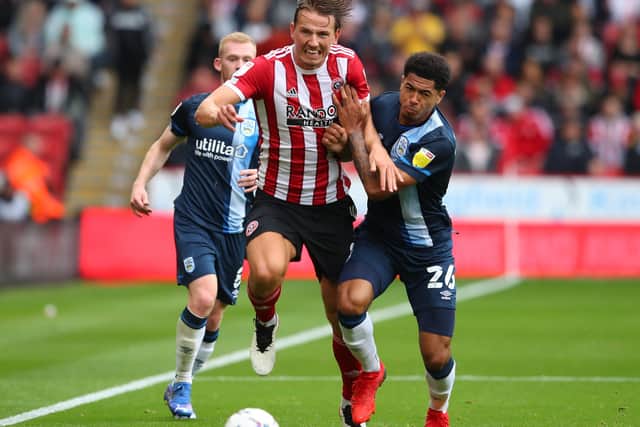 Huddersfield's  Levi Colwill  tussles with Sander Berge of Sheffield Utd. Pictures: Simon Bellis / Sportimage