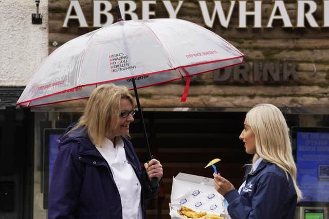 Marie Paling, head chef at Abbey Wharf restaurant and Yasmin Tonna, from Whitby, using the umbrella