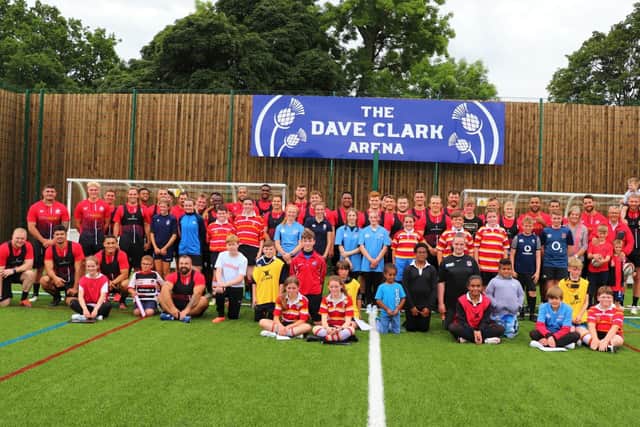 The Saracens squad with children at the new Dave Clark Arena