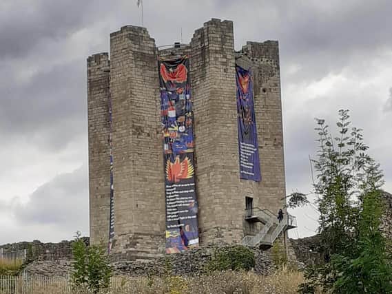 The banners now adorn the castle keep