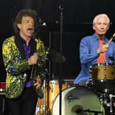 Rolling Stones drummer Charlie Watts, right, performs behind Mick Jagger in 2019
