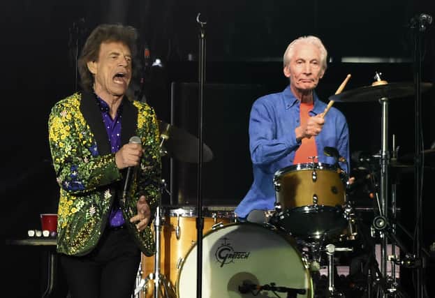 Rolling Stones drummer Charlie Watts, right, performs behind Mick Jagger in 2019
