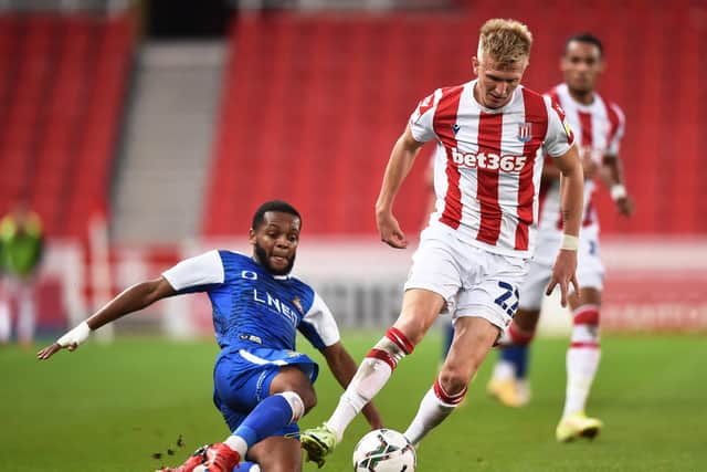 Stoke City's Sam Surridge runs past Doncaster Rovers' Anthony Greaves during the Carabao Cup Second Round clash on Tuesday night. Picture: Nathan Stirk/Getty Images