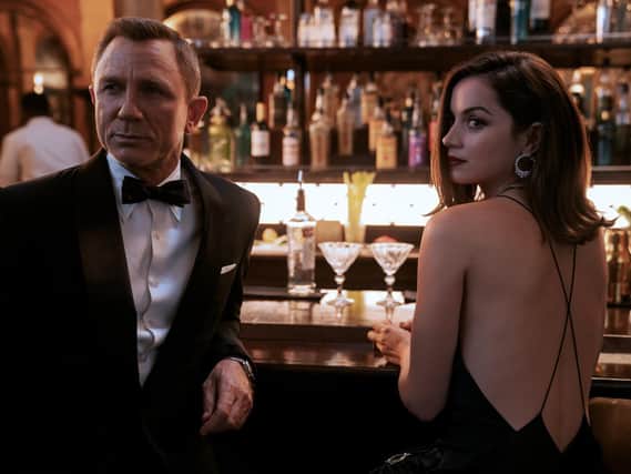 Photo issued by Danjaq, LLC/MGM of (left to right) Daniel Craig playing James Bond and Ana de Armas playing Paloma in the new Bond film No Time To Die. Picture: Nicola Dove.