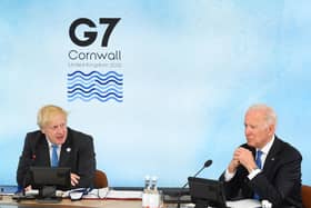 British Prime Minister Boris Johnson and US President Joe Biden sit around the table at the top of the G7 meeting in Carbis Bay, on June 11, 2021. Photo by Leon Neal - WPA Pool/Getty Images.