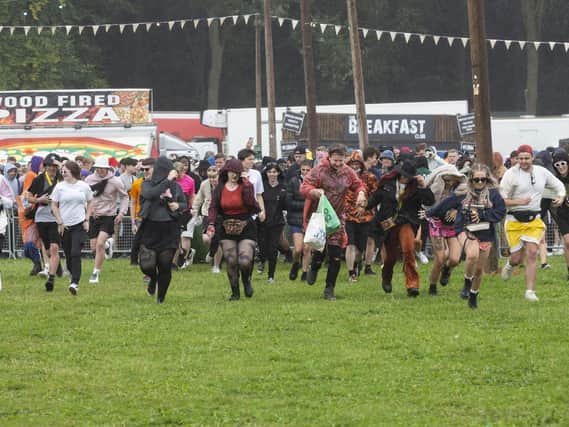 People run to the checking gates as they enter the main arena, at Leeds Festival, for the first time as the festival gets underway, pictured in West Yorks, Aug 27 2021.	Picture: Lee McLean/SWNS.