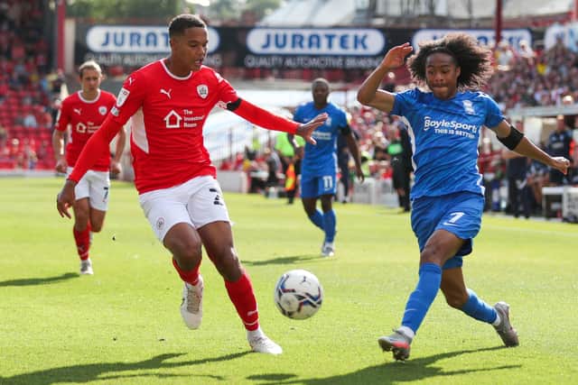TOUGH DAY: Barnsley's Toby Sibbick (left) and Birmingham City's Tahith Chong battle for the ball at Oakwell on Saturday. Picture: Isaac Parkin/PA