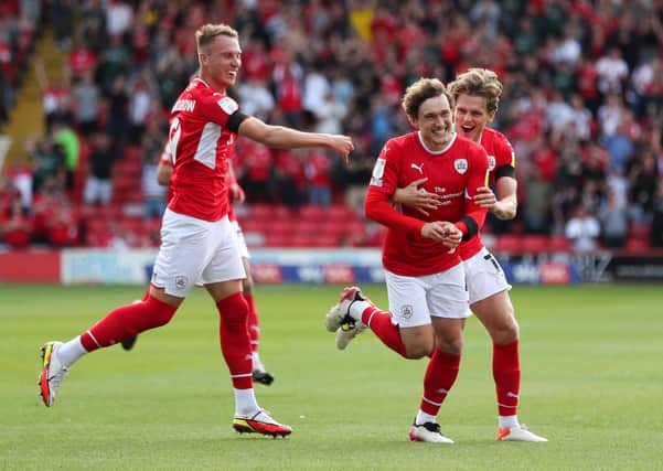 Barnsley's Callum Styles (centre) celebrates opening the scoring against Birmingham City at Oakwell on Saturday. Picture: Isaac Parkin/PA