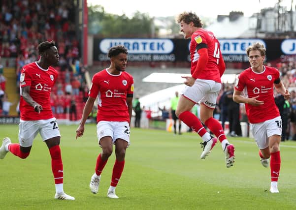 Barnsley's Callum Styles (second right) celebrates scoring his team's opener at Oakwell against Birmingham City on Saturday. Picture: Isaac Parkin/PA