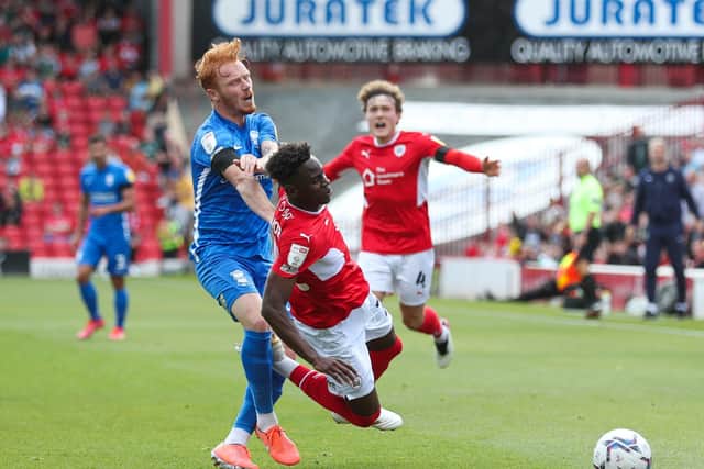 BATTLE FOR THE BALL: Barnsley's Clarke Oduor (left) and Birmingham City's Ryan Woods clash at Oakwell. Picture: Isaac Parkin/PA