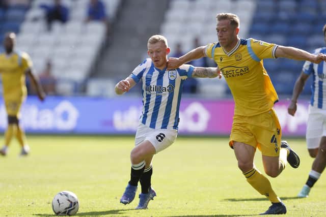 IMPRESSIVE: Huddersfield Town midfielder Lewis O'Brien of battles with Michael Morrison of Reading at Kirklees Stadium on Saturday. Picture: John Early/Getty Images
