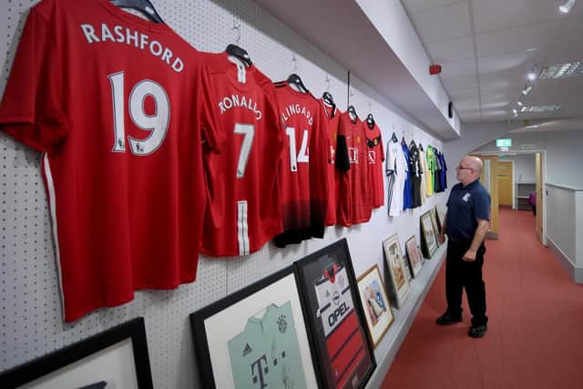 Rob Lea is pictured looking at shirts at the auction