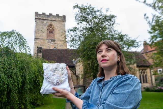 Artist Lorna Johnson with one of her many hand sewn lavender scented pew cushions. Image: James Hardisty