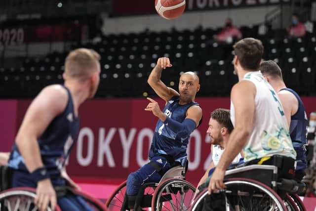 Britain's Gaz Choudhry passes the ball to team-mate during their wheelchair basketball men's preliminary round match against Australia at the Tokyo 2020 Paralympic Games, Monday, Aug. 30, 2021, in Tokyo, Japan. (AP Photo/Shuji Kajiyama)