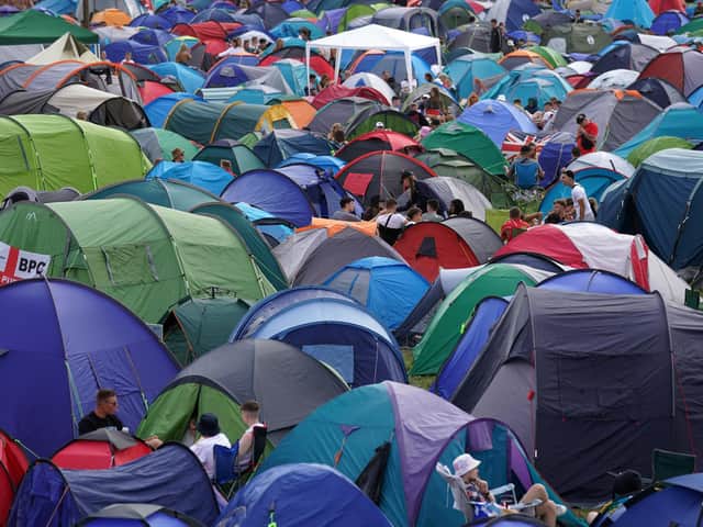 Festival goers relaxing by their tents at the Reading Festival at Richfield Avenue. (PA/Kirsty O'Connor)