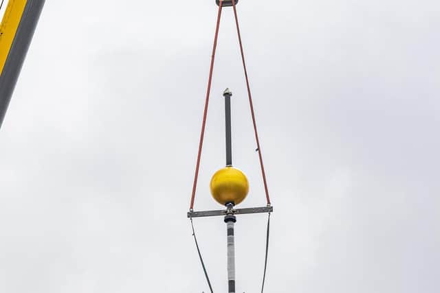 The restored time ball is craned back on top of Hull's Guildhall Picture: Tony Johnson