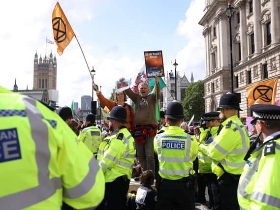 Extinction Rebellion protesters gather in Whitehall on August 24, 2021 in London. (Photo by Dan Kitwood/Getty Images).