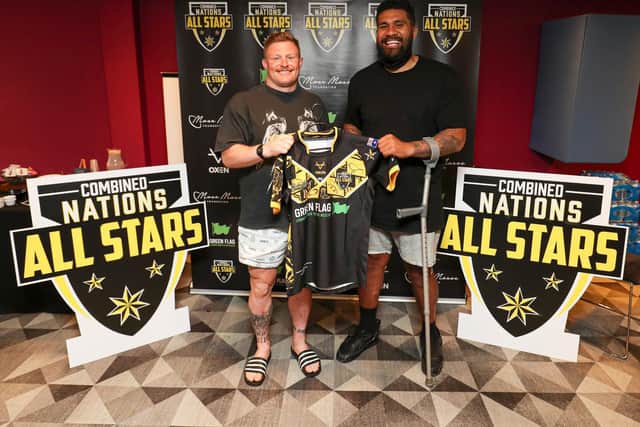 Luke Yates, left, receives his Combined Nations All Stars jersey from Mose Masoe ahead of their win against England in June. (PAUL CURRIE/SWPIX)