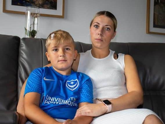 Reggie Mears, eight, with mum Ocean Parrack, recovering at home after suffering a fractured skull from a falling brick. Picture: Alex Shute