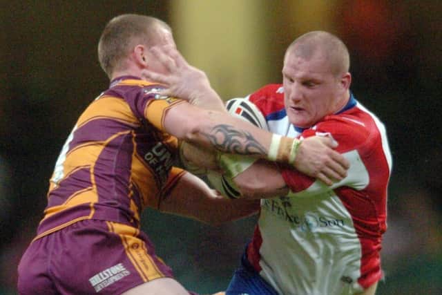 Millennium Magic: 
Huddersfield Giants v Wakefield Wildcats
Richard Moore of Wakefield hands off Kevin Brown back in 2007 (Picture: Steve Riding)