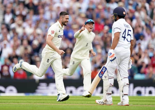 England's Chris Woakes celebrates taking the wicket of India's Rohit Sharma, caught by England's Jonny Bairstow. Pictures: PA.
