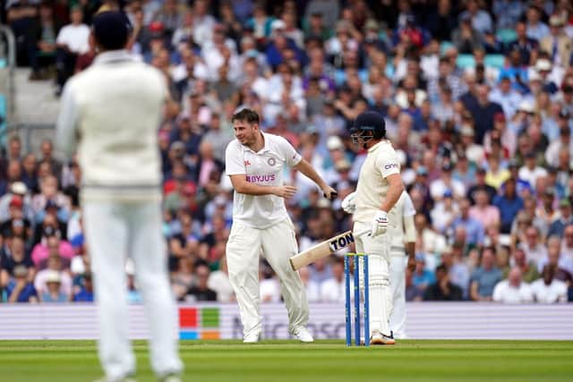 Pitch invader 'Jarvo' runs across the pitch and collides with England's Jonny Bairstow at the Kia Oval Picture: Adam Davy/PA