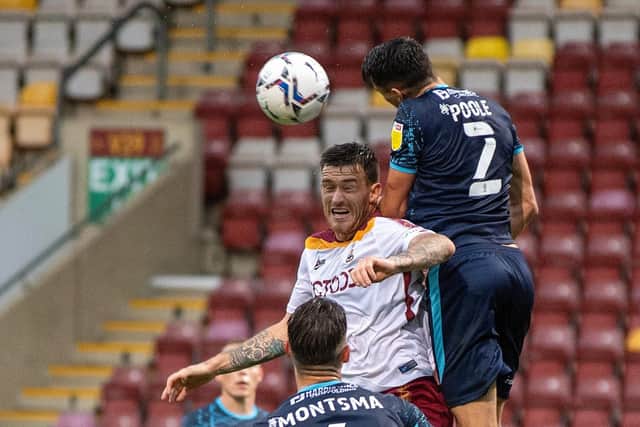 Thick of the action: Andy Cook, white shirt, in action for Bradford against Lincoln City in the EFL Trophy in midweek. (Picture: Bruce Rollinson)