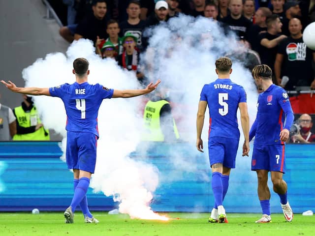 England's Declan Rice gestures towards the fans as a flare is thrown onto the pitch during the 2022 FIFA World Cup Qualifying match at the Puskas Arena, Hungary. (Picture: Attila Trenka/PA Wire)