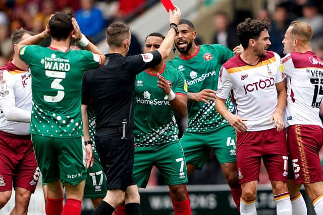 Walsall's Joss Labadie (4) is shown a red card by referee Ben Toner for a foul on Bradford City's Gareth Evans (not pictured) (Picture: Zac Goodwin/PA)
