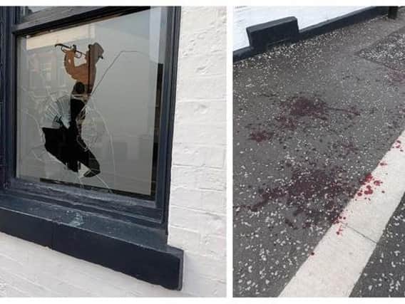 The smashed window at Trippets Lounge Bar, in Sheffield city centre, and blood on the pavement outside