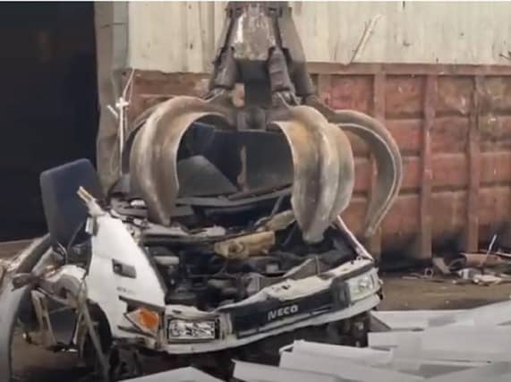 A screenshot of the video showing the van being crushed.