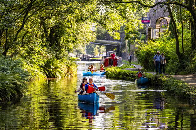 taff and volunteers at the Canal & River Trust take the opportunity for taster canoe trips on the Huddersfield Narrow Canal at Standedge Tunnel and Visitor Centre at Marsden near Huddersfield.