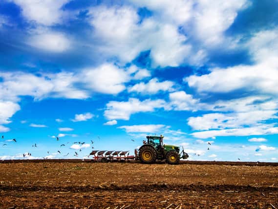 A farmer using an agriculture tractor ploughing a field near Garforth, West Yorkshire. Picture: James Hardisty