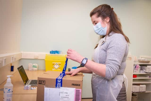 Pharmacist Rae Hynes unboxing doses of the Oxford/AstraZeneca vaccine at the Boots pharmacy in Halifax
