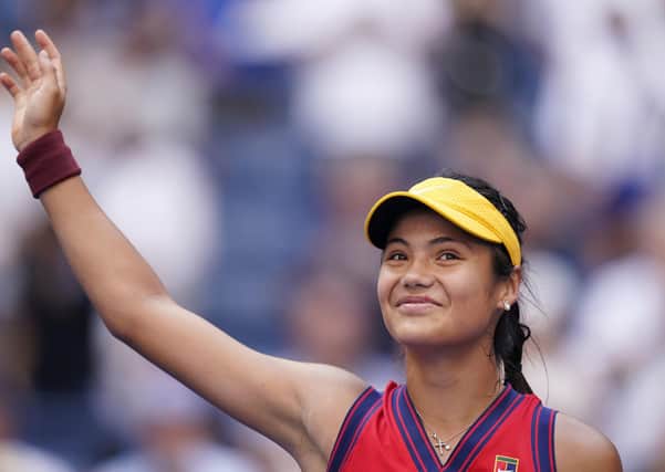 Emma Raducanu, of Britain, waves to the crowd after winning her match against Shelby Rogers, of the United States, in the fourth round of the US Open tennis championships.