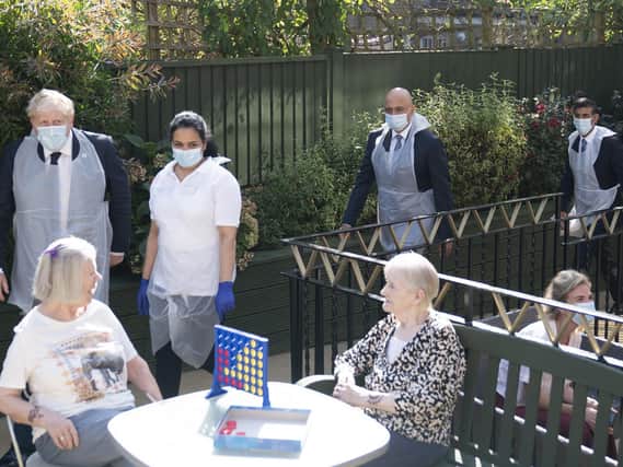 Prime Minister Boris Johnson (second left), Health Secretary Sajid Javid and Chancellor of the Exchequer Rishi Sunak (right) talk to residents Doreen (left) and Janet during a visit to Westport Care Home in Stepney Green, east London, ahead of unveiling his long-awaited plan to fix the broken social care system. (Paul Edwards/The Sun)