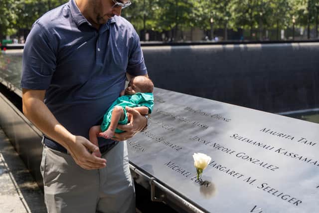 Jonathan Egan with his newborn son at the ground zero memorial in New York.