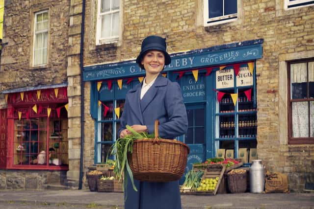 Home from home - 
Mrs Hall (Anna Madeley) in Darrowby square, which is really Grassington in the Dales, dressed to look like the 1930s.