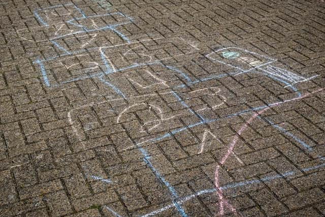 The children used the chalk to play hopscotch and to doodle