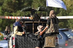 Taliban fighters in a vehicle patrol a street in Kabul on August 27, 2021, as last-ditch evacuation flights took off from Kabul airport on August 27. Photo by AAMIR QURESHI/AFP via Getty Images.
