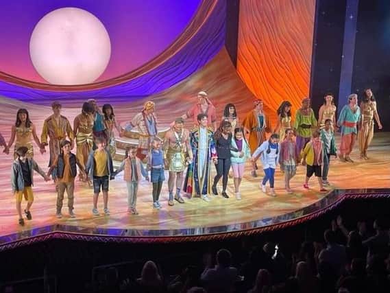 Holly-Jade Roberts with the full cast of Joseph and the Technicolor Dreamcoat onstage at the London Palladium.