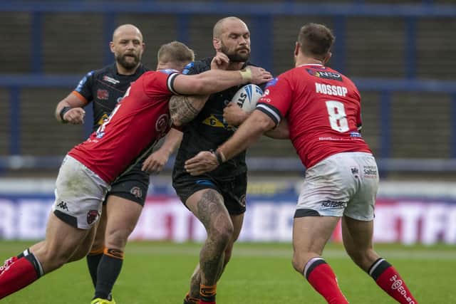 BIG PUSH: Castleford Tigers' George Griffin stopped by Salford's James Greenwood and Lee Mossop.  Picture: Tony Johnson
