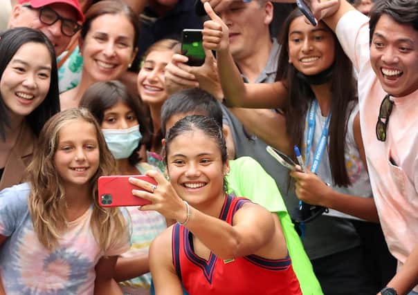 Teenager Emma Raducanu takes selfies with fans at the US Open. (Picture: Matthew Stockman/Getty Images)