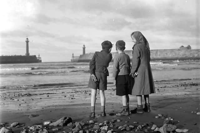 The Tindale archives: Children and piers at low tide.