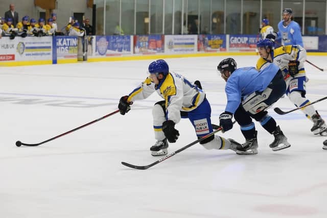 Leeds Knights' Kieran Brown stretches to keep control of the puck under pressure from a Sheffield Steeldogs' defenceman. Picture: Andy Bourke/Podium Prints.