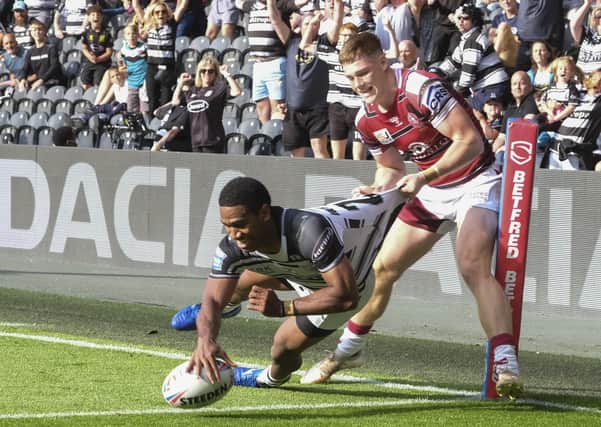 Strong arm: Hull FC’s Mitieli Vulikijapani and the home fans thought he had scored a try but Wigan’s Ethan Havard had other ideas in the 10-0 defeat.Picture: Dean Atkins/SWpix.com
