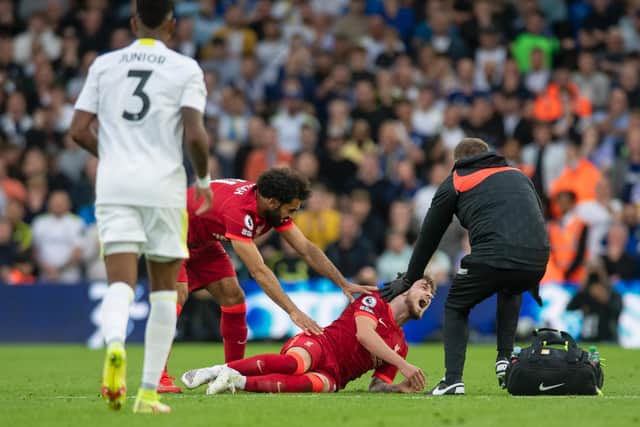 INJURY: Liverpool's Harvey Elliott goes down in pain before being stretchered off