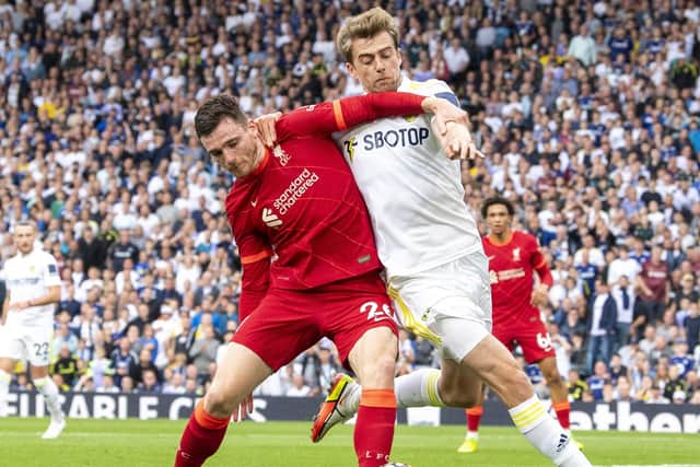 Leeds United's Patrick Bamford tangles with Liverpool's Andy Robertson.  Picture: Tony Johnson